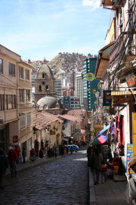 Photo of a cobblestone street bordered by shops