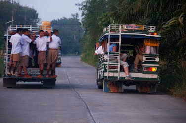 Team members on way to work site wave to passing students