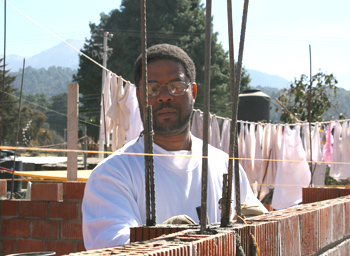 Man working on brick wall